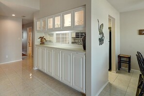 A kitchen with white cabinets, a countertop, and a decorative bird sculpture. - Dock Holiday 2 Bedroom Condo by Redawning (Rockport)
