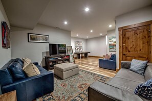 A spacious living room with a large TV, a pool table, and comfortable seating areas. - Mountain Lodge Oasis | 6BR w/ Hot Tub Near Aspen (Carbondale)