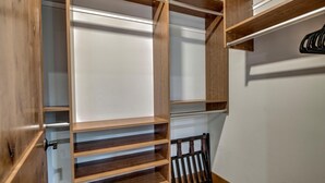 A walk-in closet with open shelves and a hanging rod. - Mountain Lodge Oasis | 6BR w/ Hot Tub Near Aspen (Carbondale)