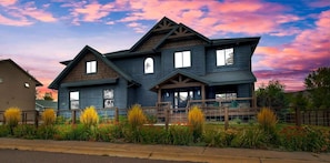 A two-story house with a gabled roof and a front porch. - Mountain Lodge Oasis | 6BR w/ Hot Tub Near Aspen (Carbondale)