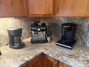 A kitchen with three coffee makers on a granite countertop. - Mountain Lodge Oasis | 6BR w/ Hot Tub Near Aspen (Carbondale)