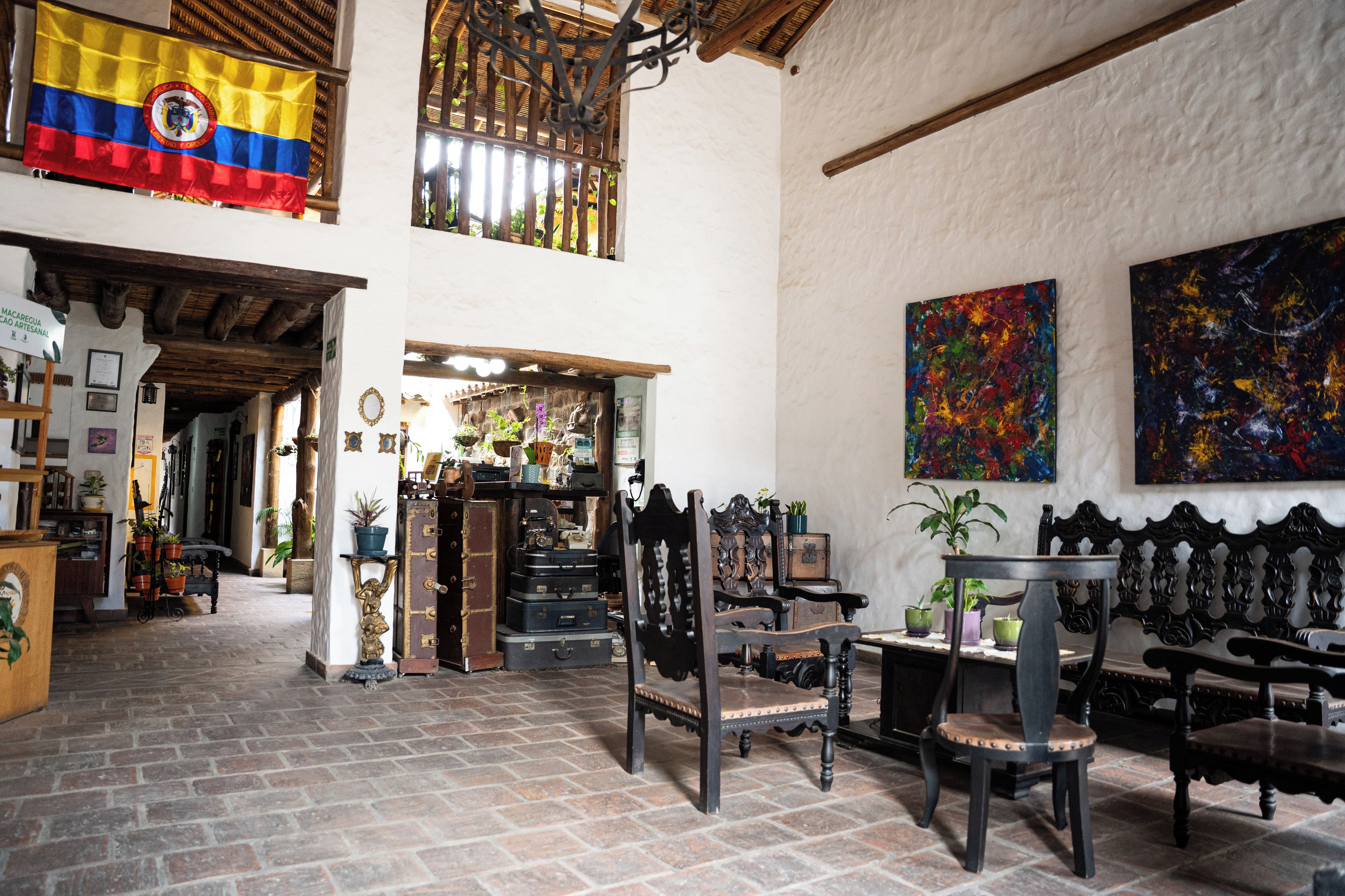 A spacious interior with high ceilings, a traditional wooden ceiling, and a mix of modern and classic furnishings.