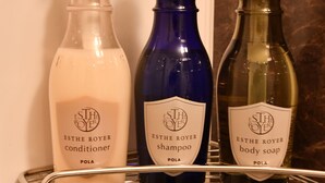 Three bottles of ESTHE ROYER products on a metal shelf in a bathroom. - FL Hotel Dotonbori (Osaka)