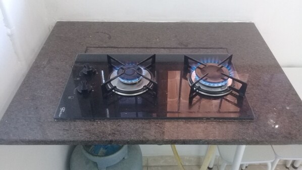 A kitchen with a gas stove and a sink.