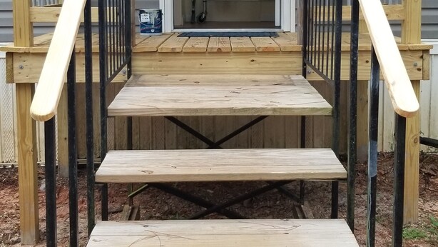 A wooden staircase leading to a covered porch with metal railings. - 1/2 acre Private Fenced Dog Friendly (Navarre)