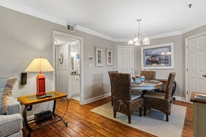 Cozy dining area with a round table and four chairs, perfect for meals and relaxation.
