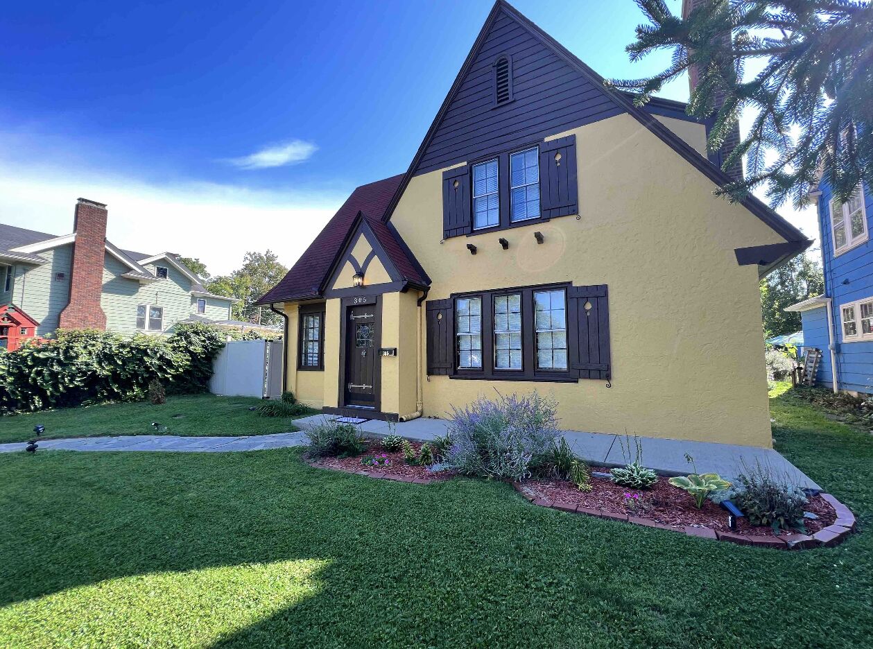 A two-story house with a gabled roof and a front porch.