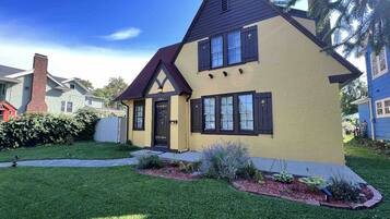 A two-story house with a gabled roof and a front porch.