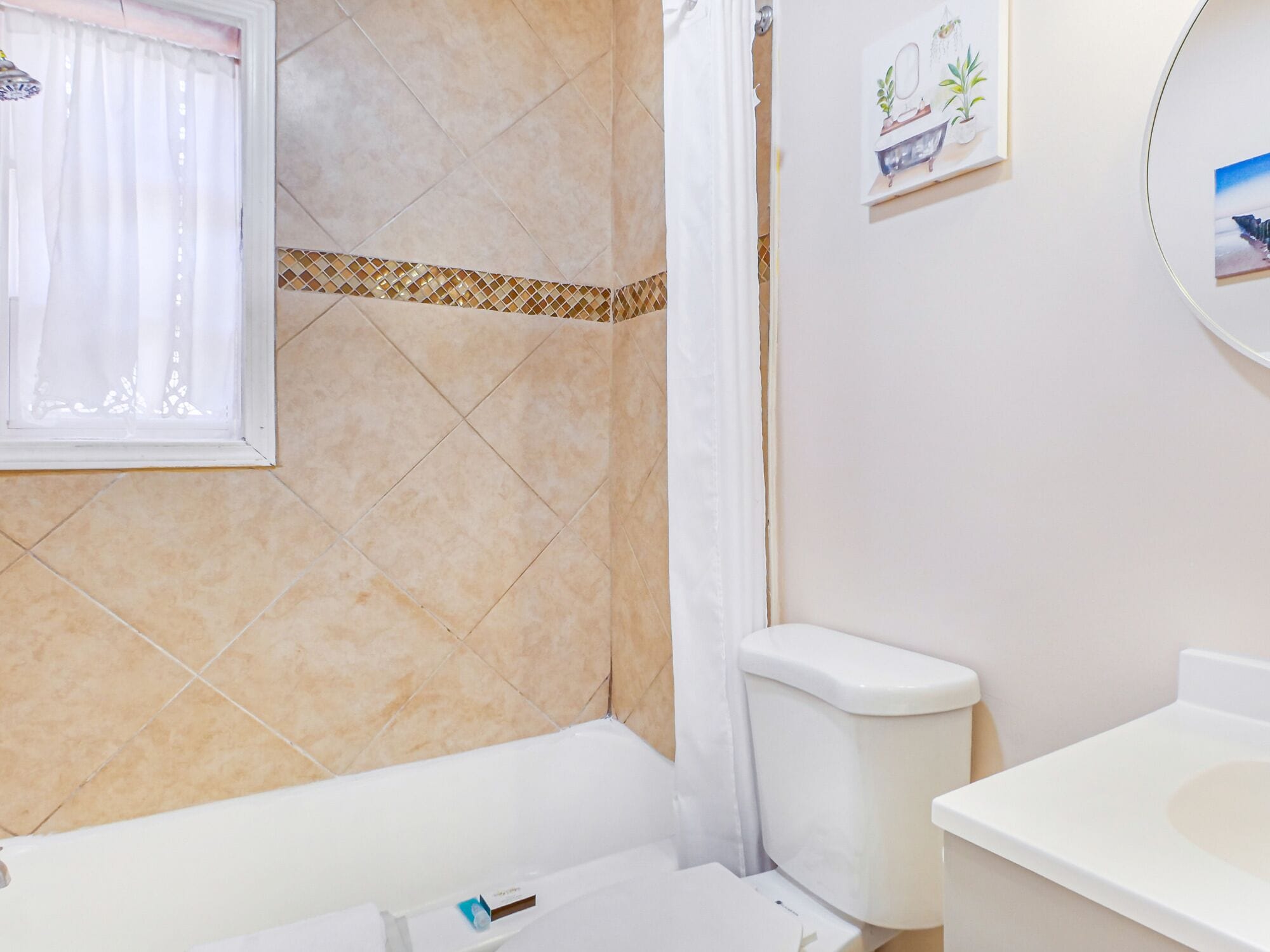 A bathroom with a bathtub, toilet, and sink.