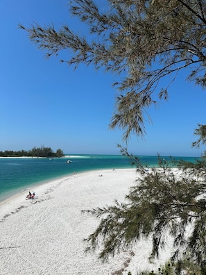 A beach with white sand, clear turquoise water, and a clear blue sky. - JD-near Beaches and IMG, Pool, Tennis, Pickleball, Shorewalk condo 2 Bedroom/2 Bath lake view (Bradenton)