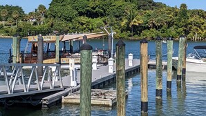 A dock with a boat named "Crest Street" and a lighthouse in the background. - Beach House just steps from Sun & Fun! (North Palm Beach)