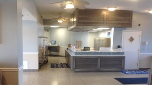 A modern kitchen with a central island, built-in cabinets, and a refrigerator.