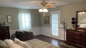 A bedroom with a bed, dresser, and a ceiling fan. - Beekeeper's House (Buena Vista)