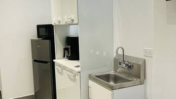 Fridge, microwave, coffee/tea maker, cookware/dishes/utensils
