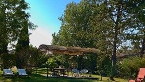 A clear blue pool with tiled edges, surrounded by lounge chairs and a covered seating area. - House with pool view (Tulette)