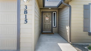 A house with a garage door, a front door with a number "3815" above it, and a small porch area. - Private Wine Country Retreat | South Nampa | Sleeps 10 (Nampa)