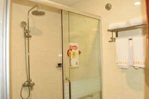 A glass-enclosed shower with a handheld showerhead and a wall-mounted faucet. There is a towel rack with folded towels on the right side. - Jinjue Hotel (Nearby Train Station) (Huizhou)
