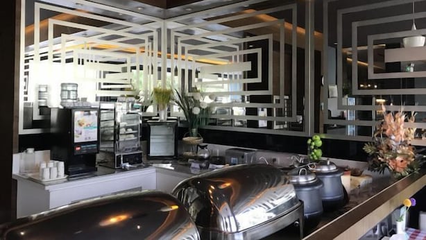 A modern kitchen with stainless steel appliances, a coffee machine, and decorative plants. - Jincheng Hotel (Bazhou Shengfang Town) (Bazhou)