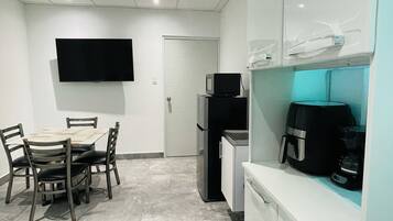 Fridge, microwave, coffee/tea maker, cookware/dishes/utensils