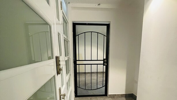 A hallway with a glass door, a metal gate, and a tiled floor. - 5 Start* *New Lovely apartment in San Juan P.R. (San Juan)