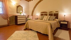 A bedroom with a bed, nightstands, a dresser, a mirror, and a window with curtains. - Cilamino by Interhome (Peccioli)