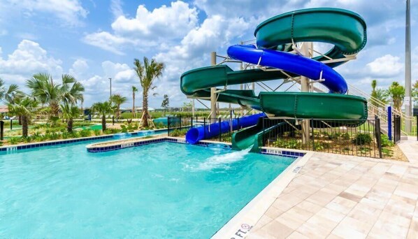 A water park with multiple slides and a pool.