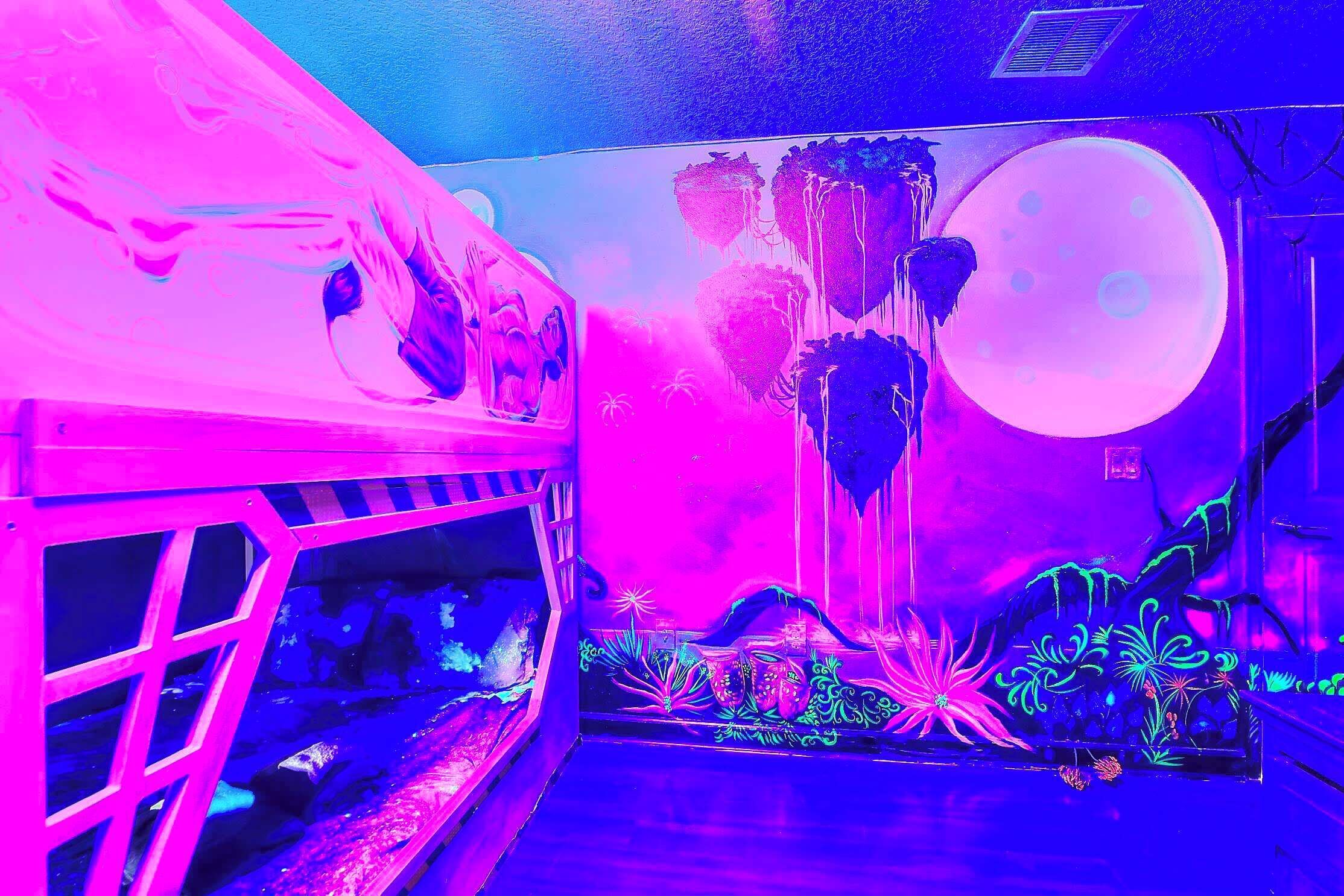 Bedroom 7: Disembark the spaceship and come down to the planet of Pandora. Sleep in the pods amongst the Navi people in this glow in dark 360 degrees custom room with twin over twin bunk bed, staircase connecting a full over full bed. Sleeps 6 adults