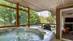A hot tub with a wooden ceiling and large windows overlooking a wooded area. - Amazing Family Retreat with PRIVATE hot tub! Steps to the Village and slopes (Whistler)