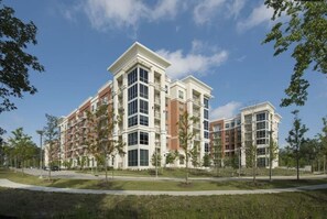 A multi-story residential building with a symmetrical facade, large windows, and a flat roof. - Spacious 2 bed/ 2 bath Apartment in Spring, TX (Spring)
