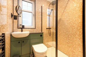 Bathtub, hair dryer, slippers, towels
