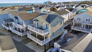 A coastal residential area with multiple two-story houses featuring balconies and waterfront views. - Country music festival! Ocean Lake Campground house.  (Myrtle Beach)