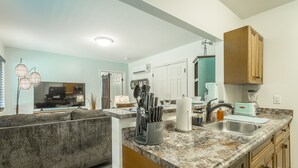 A modern kitchen with granite countertops, a sink, and wooden cabinets. - ✤VILLA CATALINA✤ Private Studio #103 (Chattanooga)