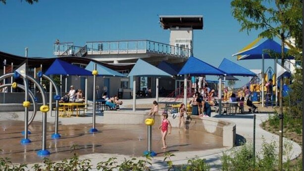 A water park with play structures, seating areas, and a lifeguard tower. - The Grey Beach House!! In the heart of Grand Bend (Grand Bend)