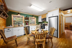 Enjoy meals in the kitchen with a microwave and stainless steel refrigerator, surrounded by comfortable seating.