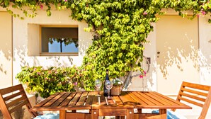 A wooden table with two chairs, a bottle, and two wine glasses. - Historic & Emblematic - Convent of Bernardas (Tavira)