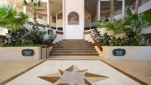 A hotel entrance with a star-shaped floor design, wooden steps, and signs for 'Conference Room' and 'Elevator Access'. - Sandcastle Court #219 & 220 (Nassau County)