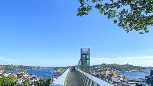 A pedestrian bridge with a glass tower, overlooking a coastal town and water. - Stunning apartment in Arendal with WiFi (Arendal)