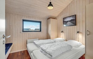 Cozy retreat with a sloped ceiling, large window, and bench.