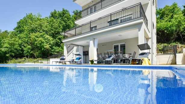 A modern two-story building with a swimming pool, outdoor seating, and a covered patio area. - Stunning home in Sinj (Sinj)