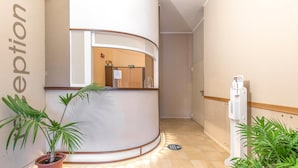 A reception area with a curved reception desk, a water dispenser, and potted plants. - Nice apartment in Villasimius with WiFi (Villasimius)