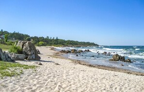 A sandy beach with large rocks and waves crashing onto the shore. - Nice home in Allinge with kitchen (Allinge)