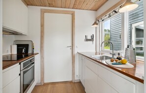 Fridge, stovetop, dishwasher, coffee/tea maker