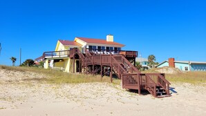 A beachfront house with a wooden staircase leading to a balcony. - Great price!Beachfront with Stunning gulf view from this Great home with hot tub (Saint George Island)