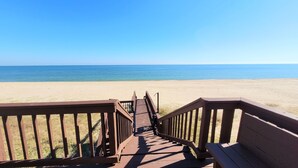 A wooden boardwalk leading to a beach with clear blue water. - Great price!Beachfront with Stunning gulf view from this Great home with hot tub (Saint George Island)