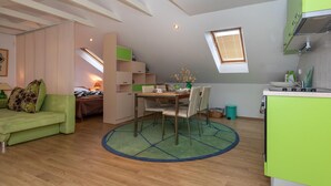 A compact living space with a dining area, kitchenette, and a loft bedroom. - 2 bedroom gorgeous home in Blace (Blace)