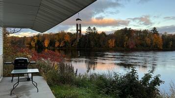 Enjoy a serene lakeside retreat with a gazebo, grill, and stunning views of the surrounding autumn foliage.