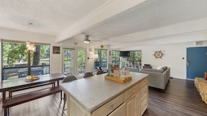 A spacious kitchen with a large island, dining area, and a view of the outdoors. - Lakefront Chalet w/ Covered Boat Dock - Sleeps 8 - 1 Hour from Dallas (Malakoff)