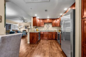 Enjoy cooking in this well-equipped kitchen with an oven, granite countertop, and stainless steel appliances.