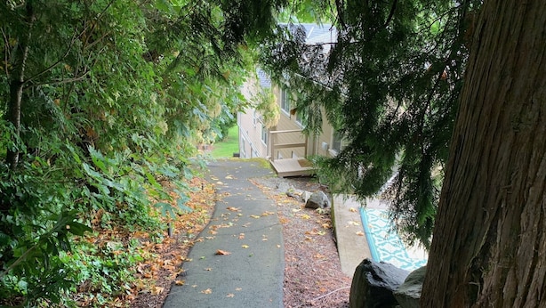 A pathway leading to a building with a pool. - Quiet, cozy 1 bedroom suite, w/ separate entrance. Now with A/C! (North Saanich)