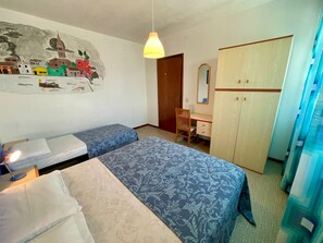 A room with two beds, a desk, a wardrobe, and a wall mural. - Seaview Flat Just 70mt From the sea (Caorle)